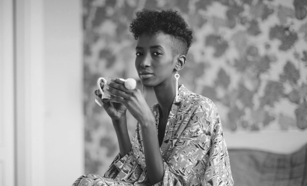 black woman drinking from a cup